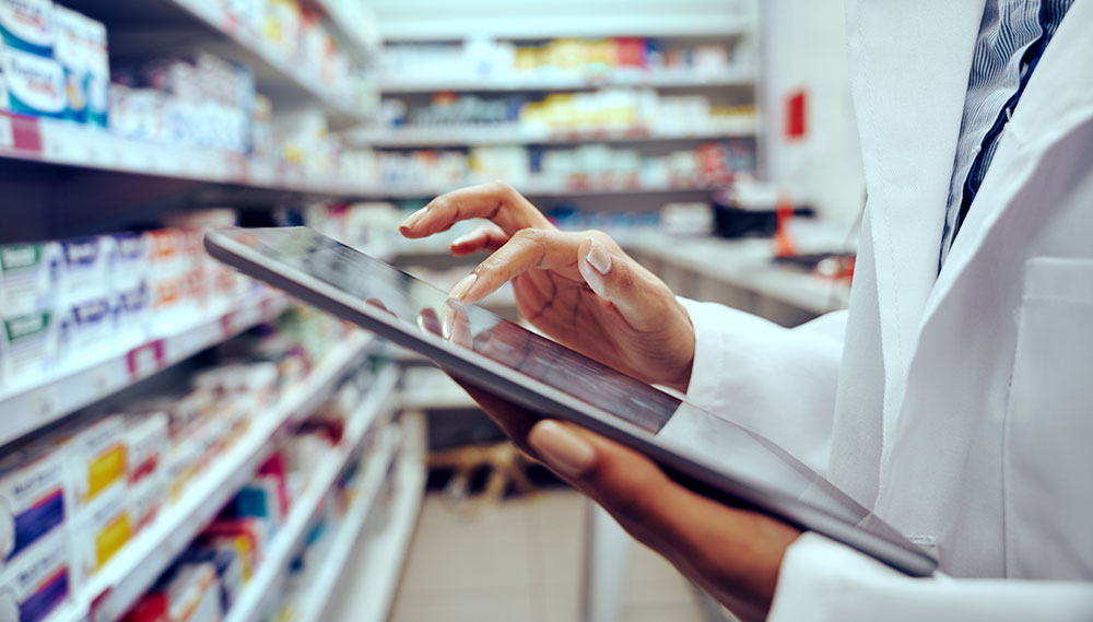 Pharmacist using a tablet computer